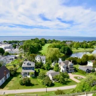 Panoramic view of Lake Michigan along a Northern Michigan road trip route, featuring sparkling blue water, shoreline scenery and expansive skies.